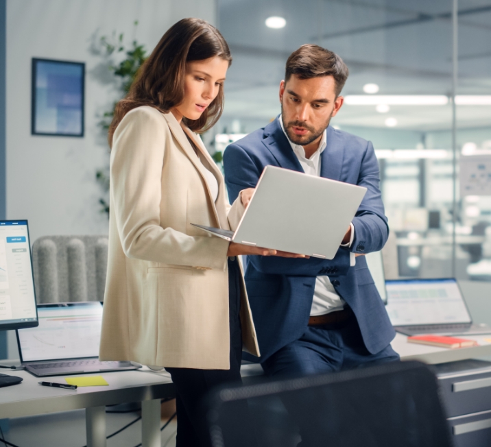 Two employees looking at notes